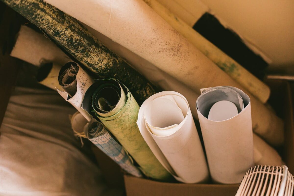 Close-up of assorted rolled papers in a box, showcasing a creative workspace ambiance.